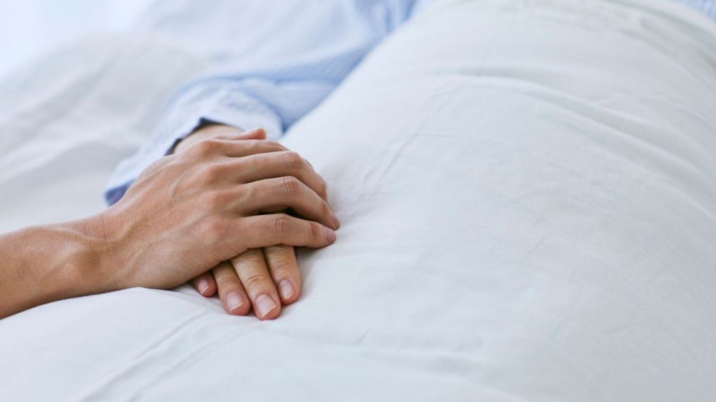 A visitor holds the patient