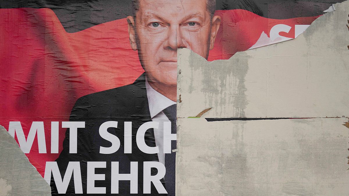 A damaged election poster showing German Chancellor Olaf Scholz is displayed on a road in Wernigerode, 26 January 2025