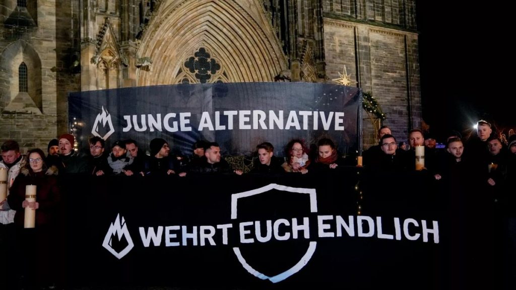 FILE: People carry banners reading