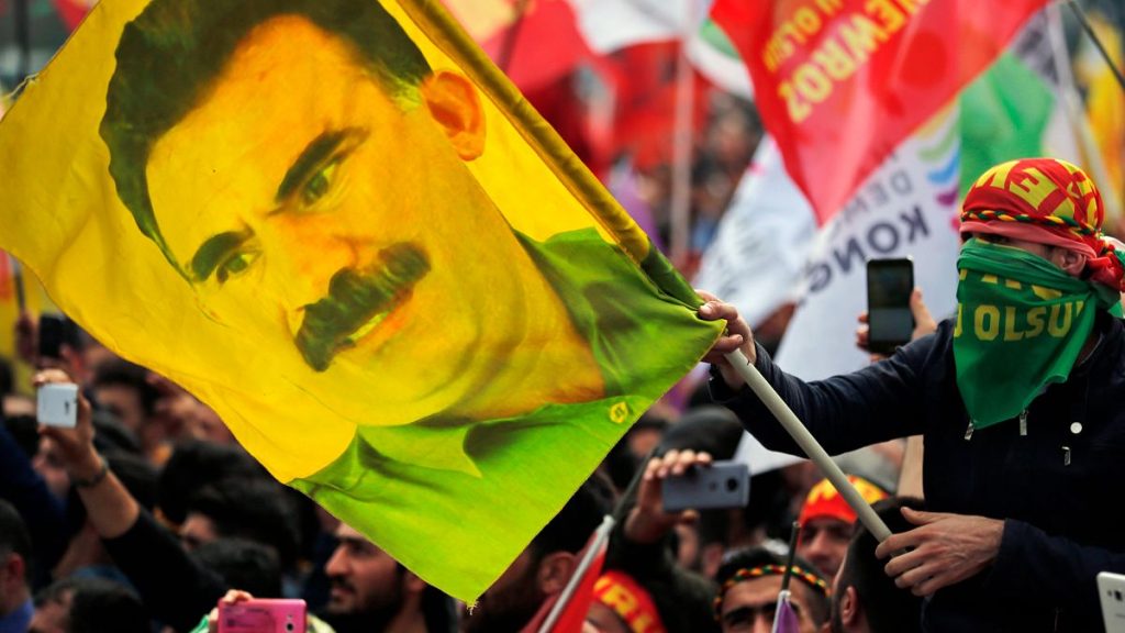 FILE: A youth holds a flag with the image of Abdullah Ocalan, the jailed leader of the rebel Kurdistan Workers