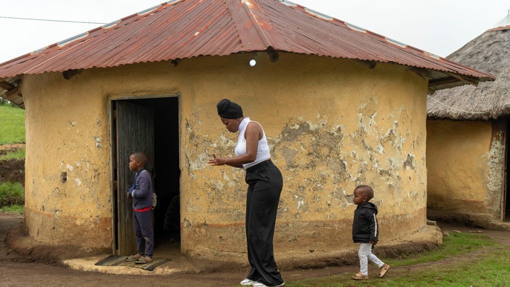 Nozuko Majola, a 19-year-old South African, walks with her children at her Umzimkhulu home in February 2025.