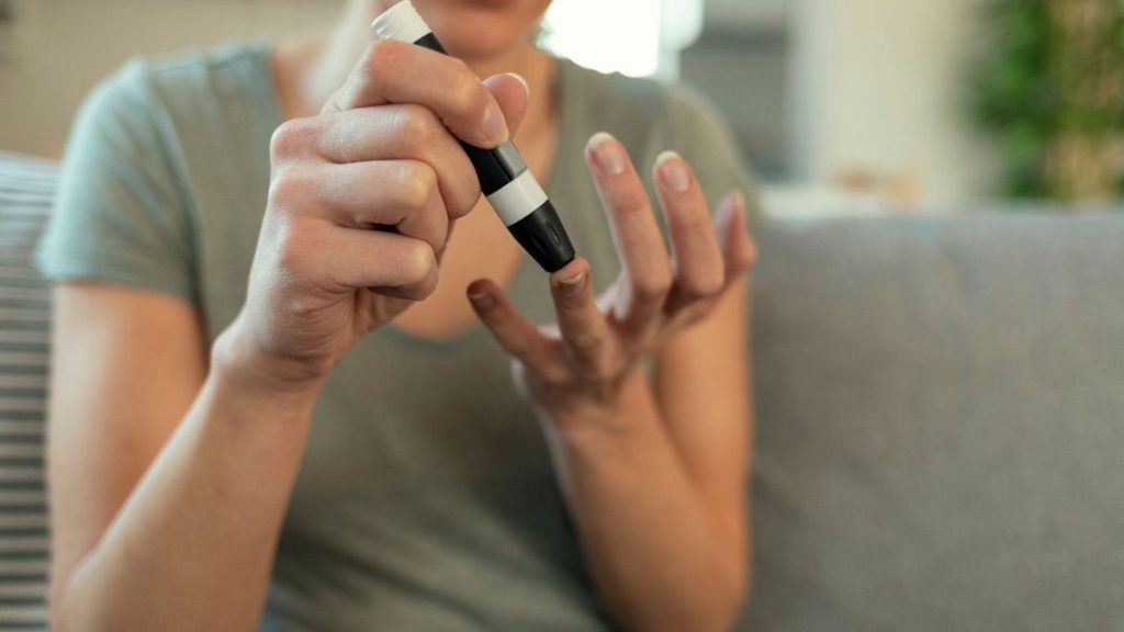 A woman checks her blood sugar levels.