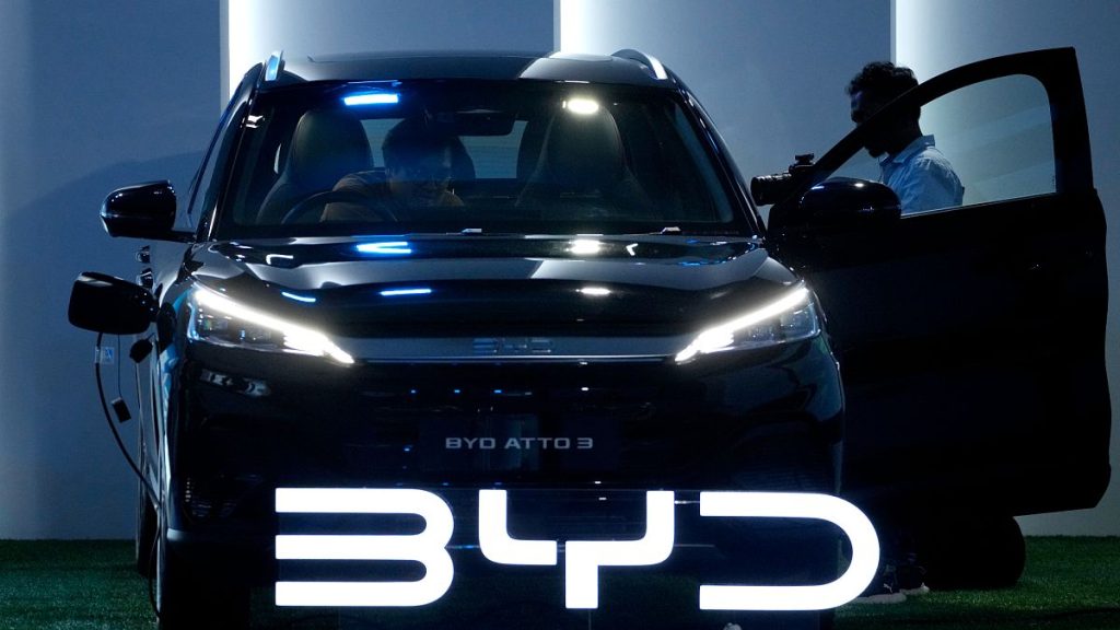 Journalists inspect a BYD Atto 3 displayed during its launch event in Jakarta, Indonesia. 18 January 2024.