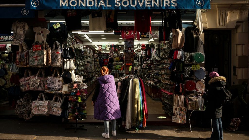 File photo of a woman looking at a souvenir shop of Montmartre during a cold day in Paris, Saturday, Jan. 5, 2025.