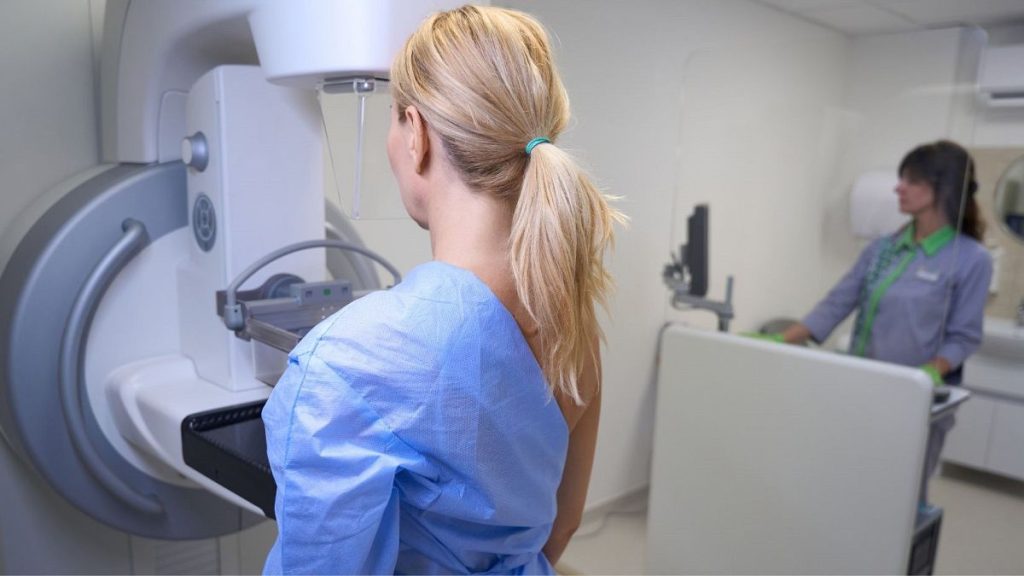 A woman gets a mammogram.