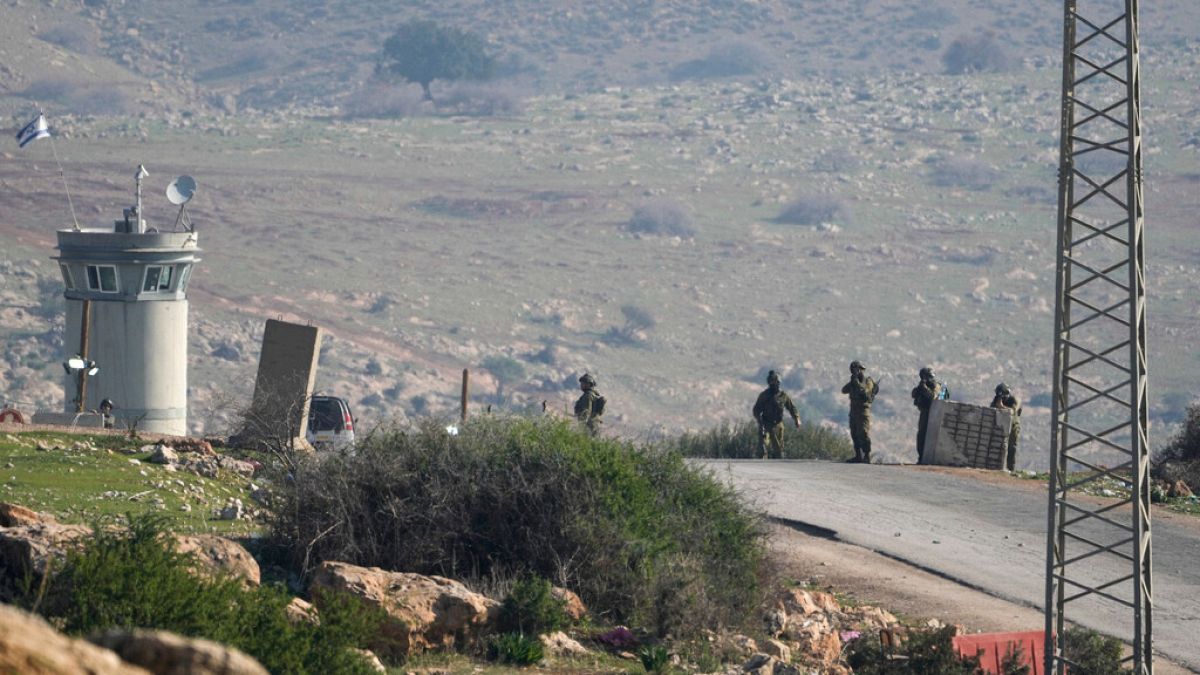 Israeli soldiers stand guard at a checkpoint where the military said an attacker fired at an army base near the village of Tayasir in the northern West Bank, Tuesday, Feb. 4,