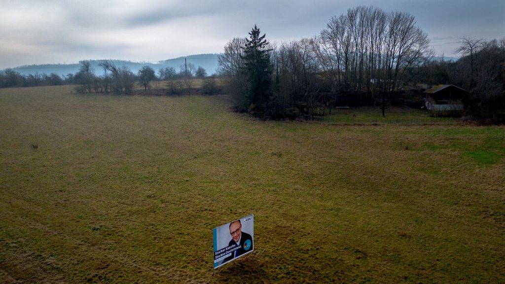 An election poster showing CDU top candidate for chancellor Friedrich Metz stands on a meadow in New-Anspach near Frankfurt, 21 February 2025