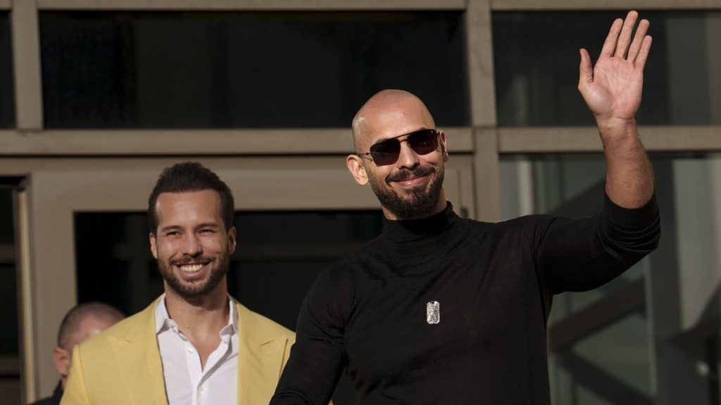 Andrew Tate waves as he exits the Bucharest Tribunal with his brother Tristan in Bucharest, Romania, on 9 January, 2025.