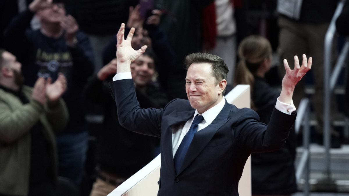 Elon Musk arrives on stage to speak at an indoor Presidential Inauguration parade event in Washington, Monday, Jan. 20, 2025.