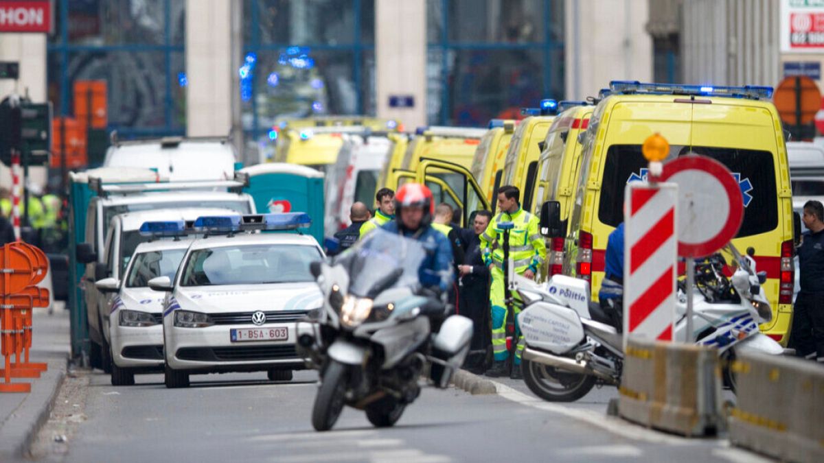 A police motorcycle rides by ambulances at a staging station near a metro after an explosion in Brussels on Tuesday, March 22, 2016.