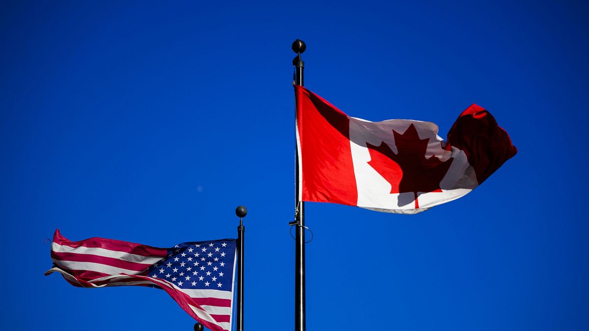 The US flag (left) and Canadian flag (right) fly side by side in Ottawa on the day Trump announces tariffs