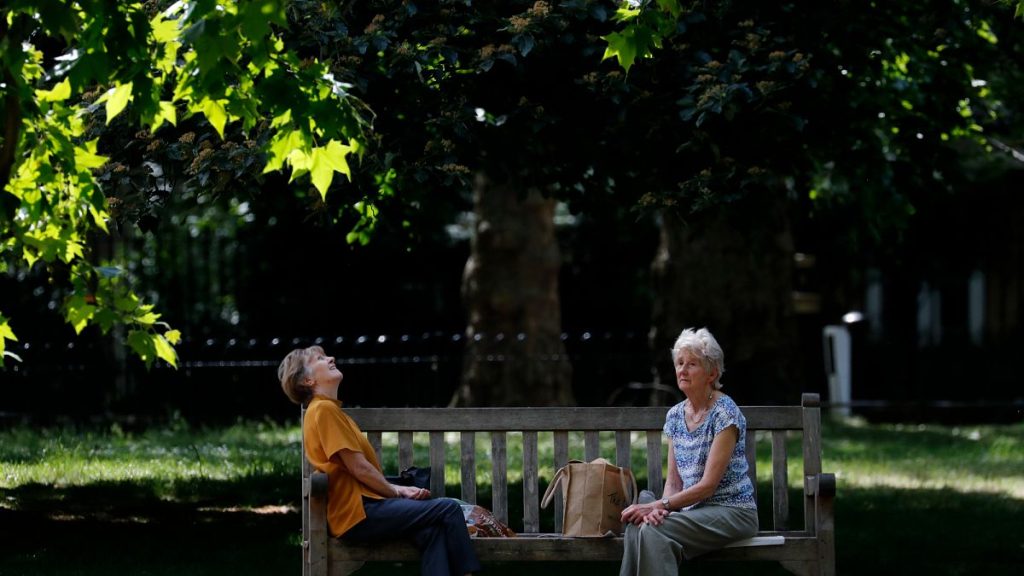 People sit on the bench in London in May 2020.