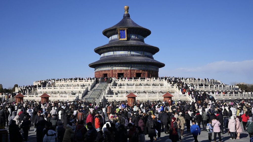 Lunar New Year revellers gather at the Hall of Prayer for Good Harvests in the Temple of Heaven complex during the week-long Chinese New Year holiday in Beijing