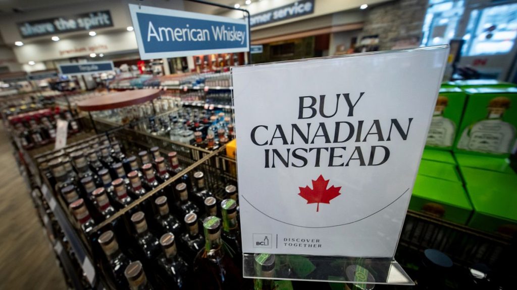 A sign is placed in front of the American whiskey section at a B.C. liquor store after top selling American made products have been removed from shelves in Vancouver, B.C.,