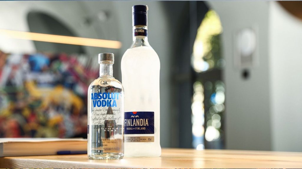 A bottle of Absolut vodka, along with a bottle of Finlandia vodka on a table. Pernod Ricard owns the Absolut brand.