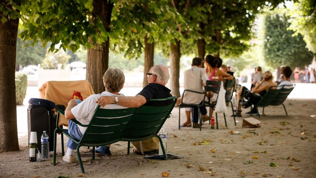 People relax in the shade in Paris in June 2022.