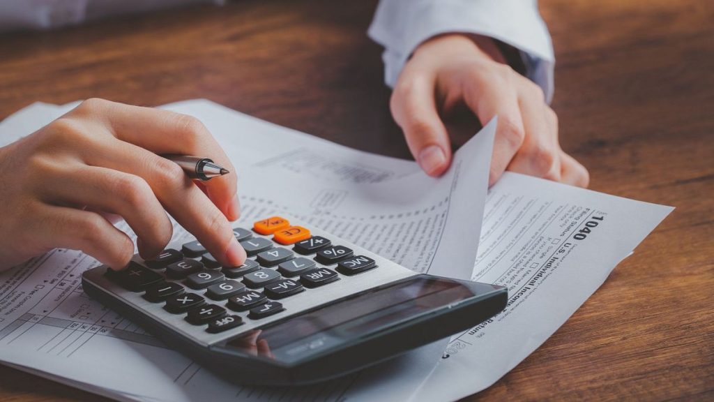 A person calculating their tax payment.