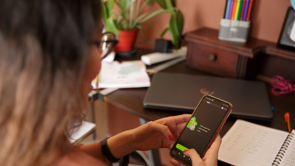 A woman with the Duolingo app open on a smartphone.