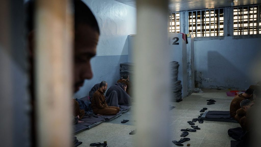 Inmates accused of being Islamic State (ISIS) fighters sit inside a cell at the Syrian Democratic Forces-run Gweiran Prison, in Hassakeh, northeastern Syria, 31 January 2025.