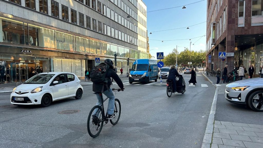 Cars drive on a road in the city centre in Stockholm, Sweden, October 2023.