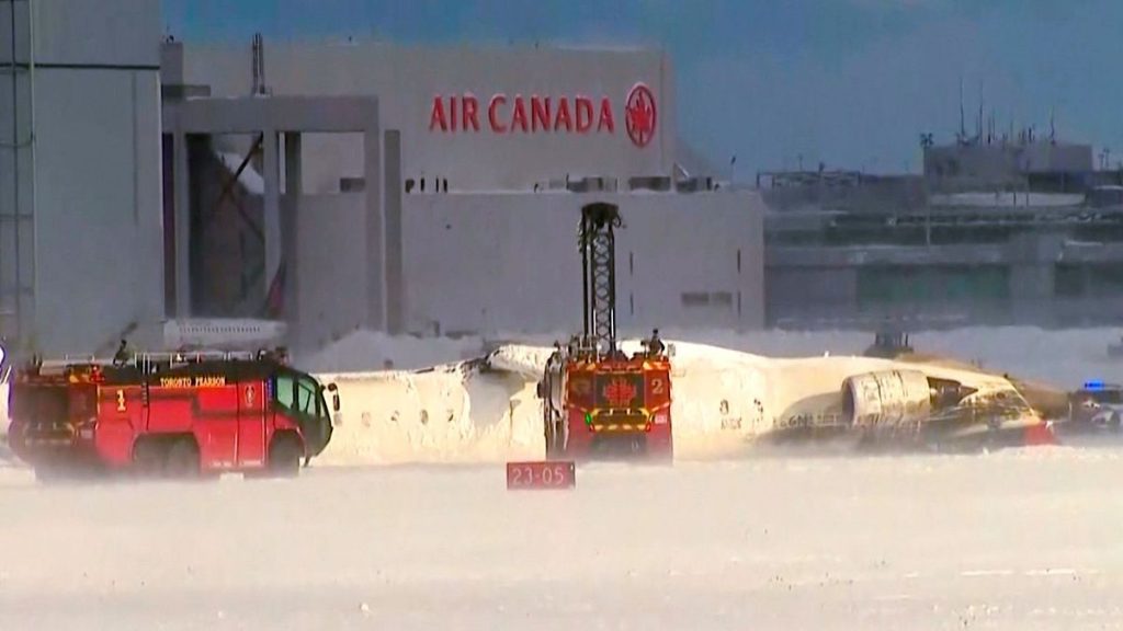 This image taken from video provided by CTV shows emergency crews responding at Toronto Pearson Airport after a plane crash, Monday, Feb. 17, 2025.