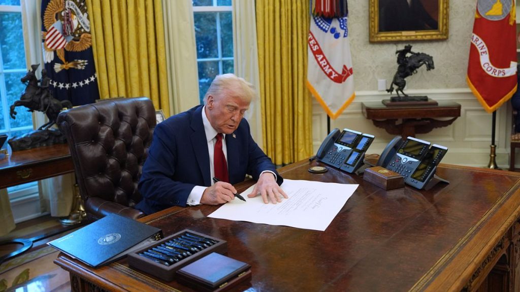 US President Donald Trump signs executive orders in the Oval Office at the White House.