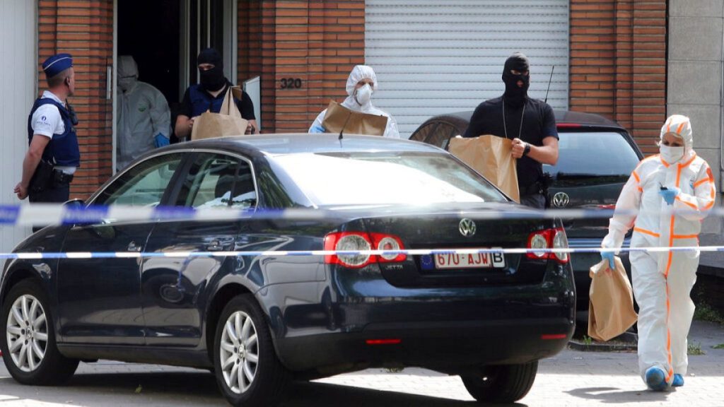 Police and forensic officers remove items during a house search in the Molenbeek district of Brussels on Wednesday, June 21, 2017.