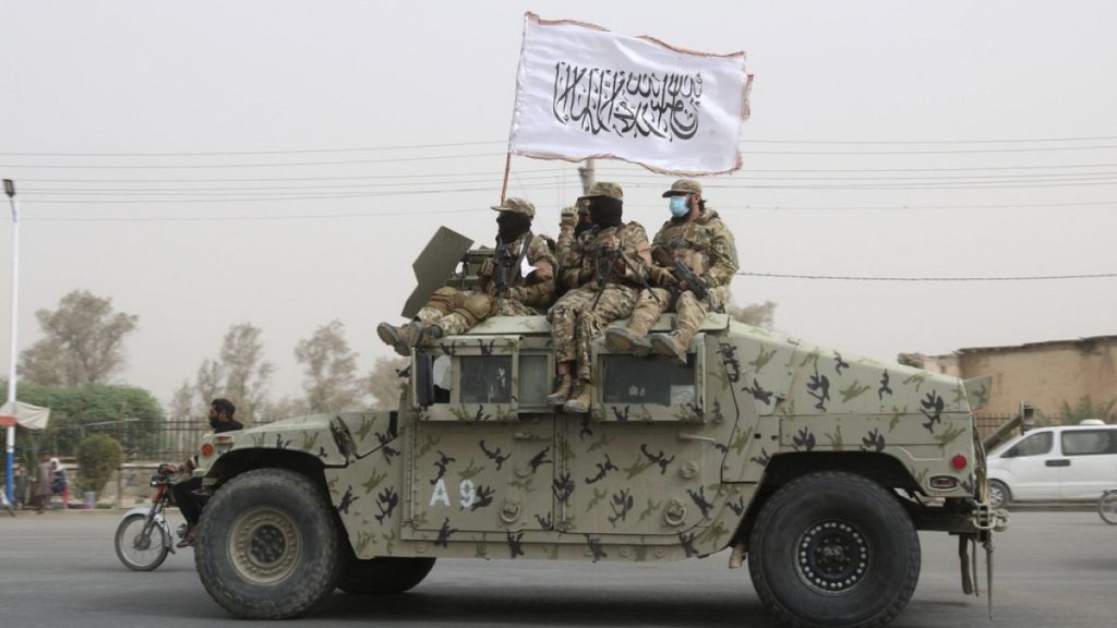FILE - Taliban fighters patrol on the road in Kandahar, south of Kabul, Afghanistan, Tuesday, Aug. 15, 2023