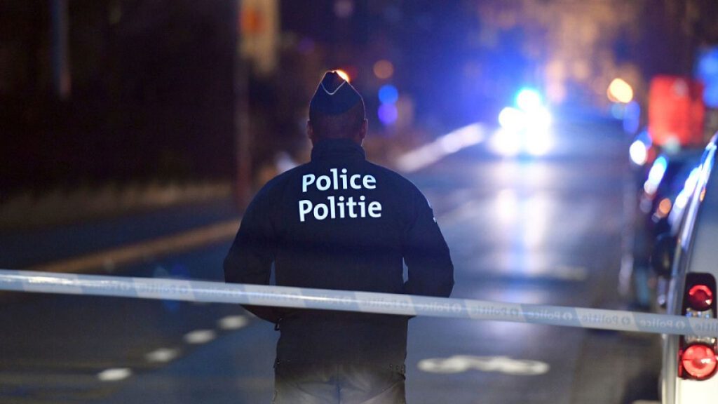A police officer stands at a cordon during the investigation of a suspect car in the center of Brussels on Thursday, March 2, 2017.