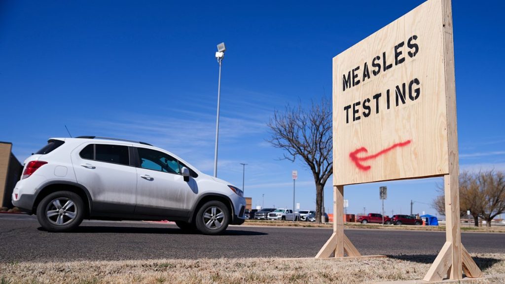 A vehicle drives past a sign outside of Seminole Hospital District offering measles testing Friday, Feb. 21, 2025, in Seminole, Texas.
