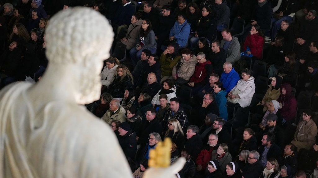 People attend a rosary prayer for the health of Pope Francis in St Peter