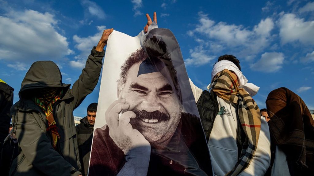 Youngsters hold a photograph of the jailed leader of the PKK Abdullah Öcalan in Diyarbakir, 27 February, 2025