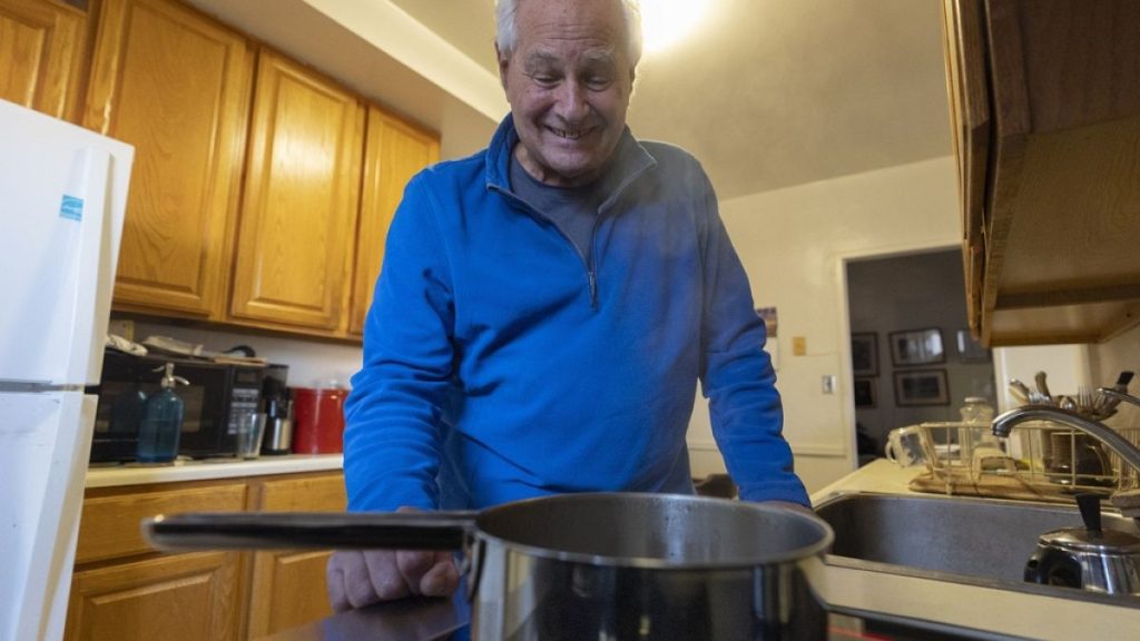 Ed Yaker boils water on an electric induction stove