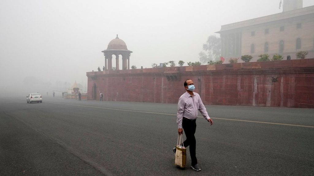 A pedestrian wears a face mask amidst a thick layer of smog in New Delhi, India.