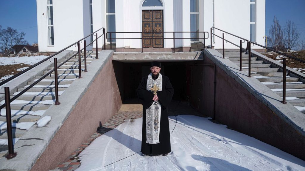 An Orthodox priest Andrii stands near his church during a memorial ceremony to mark the third anniversary of the Russian invasion of Ukraine, in Bucha, Ukraine, Feb. 24, 2025.
