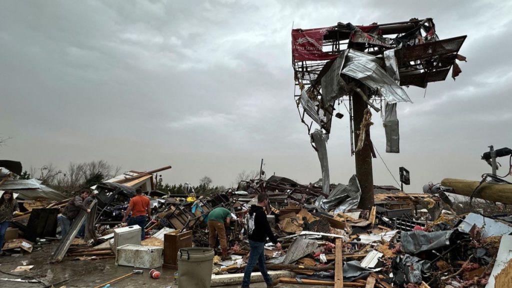 People work through the debris of the Cave City Auto Parts store on Saturday, March 15, 2025 after a severe weather storm
