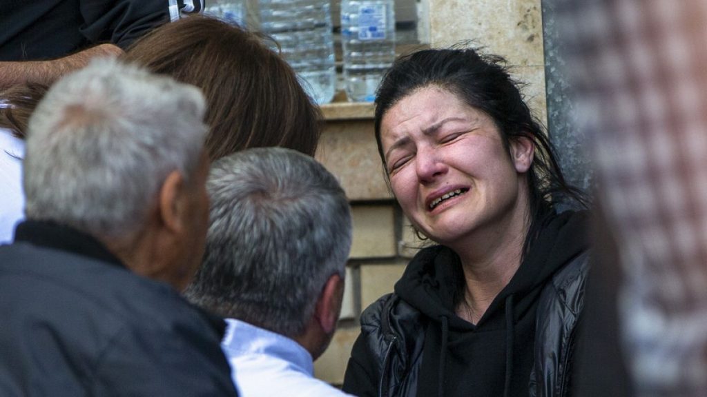 A woman cries outside a hospital in the town of Kocani, North Macedonia, Sunday, March 16, 2025, following a massive fire in a nightclub early Sunday