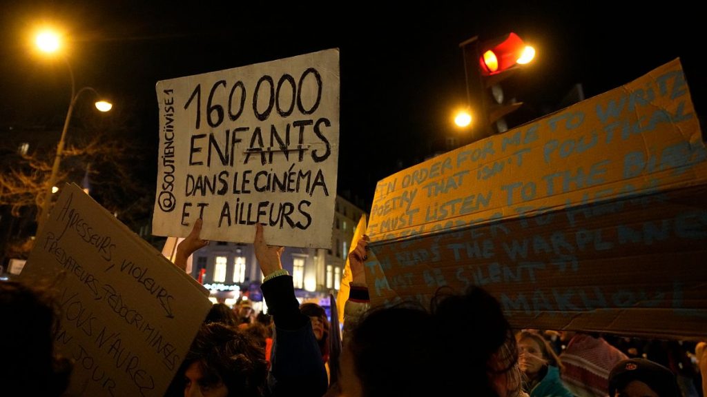 Demonstrators hold placards outside the venue of the 2024 Cesar Awards ceremony, in support of victims of sexual violence