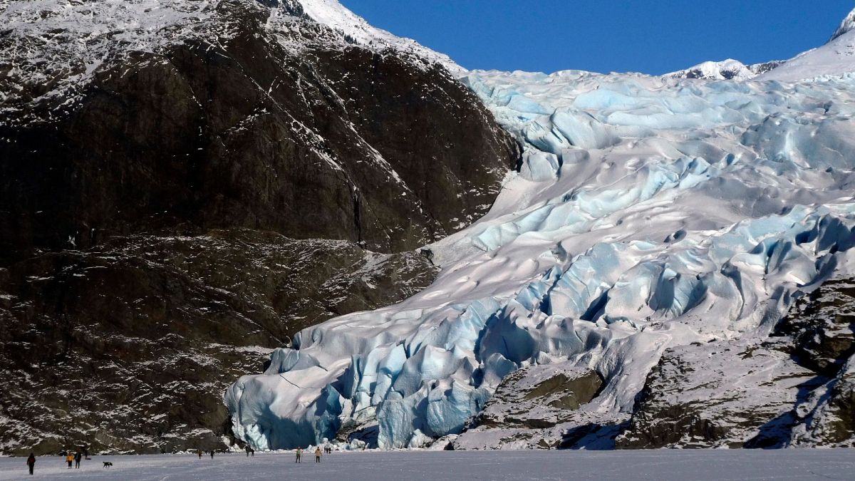People walk near the Mendenhall Glacier on Feb. 9, 2025, in Juneau, Alaska.
