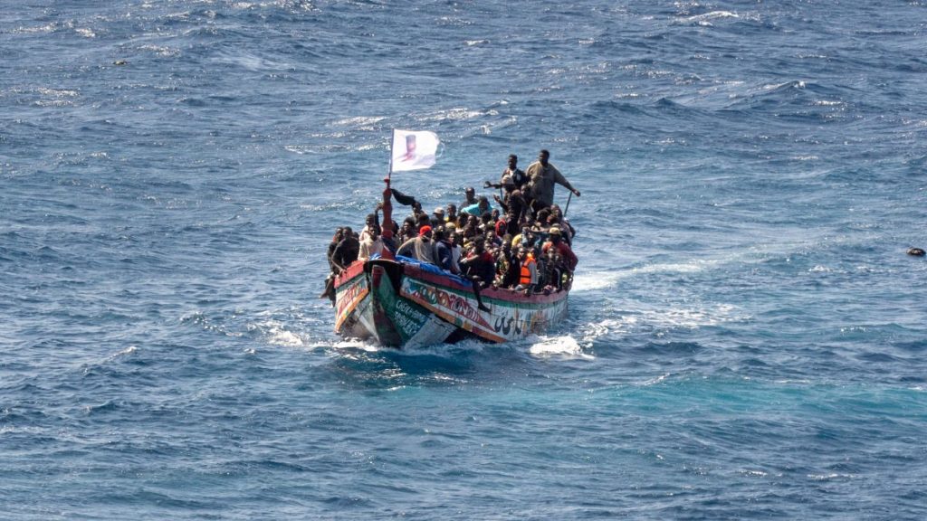 Migrants crowd a wooden boat as they sail to the port in La Restinga on the Canary island of El Hierro, 18 August, 2024