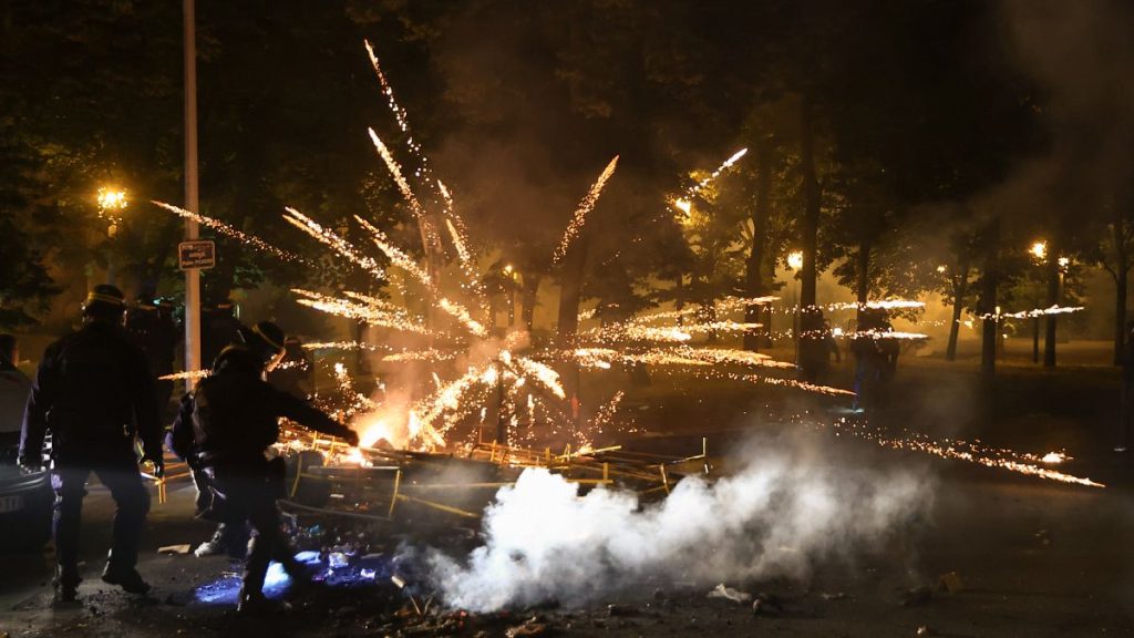 Police clear a street on the third night of protests sparked by the fatal police shooting of a 17-year-old driver in Paris, 30 June, 2023