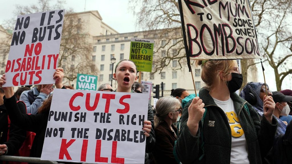 Protesters in London show placards as Britain