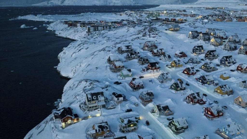 Houses covered by snow are seen on the coast of a sea inlet at Nuuk, Greenland, Friday, March 7, 2025