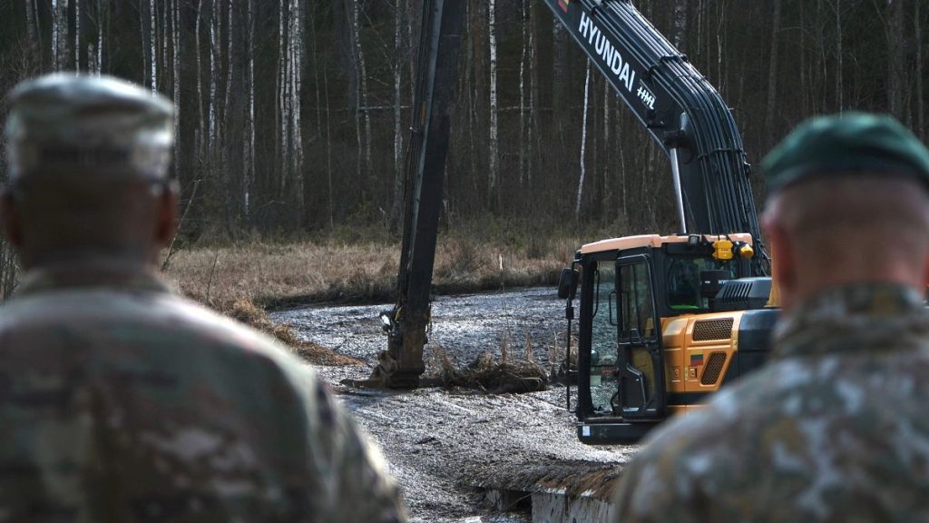 US Army soldiers watch as a swamp drainage operation is under way near Pabadre, 27 March, 2025