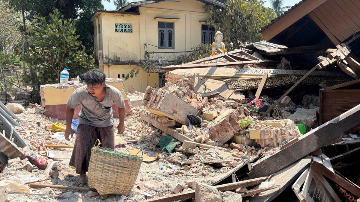 A person goes through rubble at a Buddhist monastery building that has collapsed following an earthquake in Naypyitaw, Myanmar Sunday, March 30, 2025.