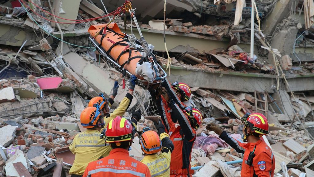 Members of a Chinese search and rescue team transfer a pregnant survivor from a collapsed building in the aftermath of an earthquake in Mandalay, 31 March, 2025
