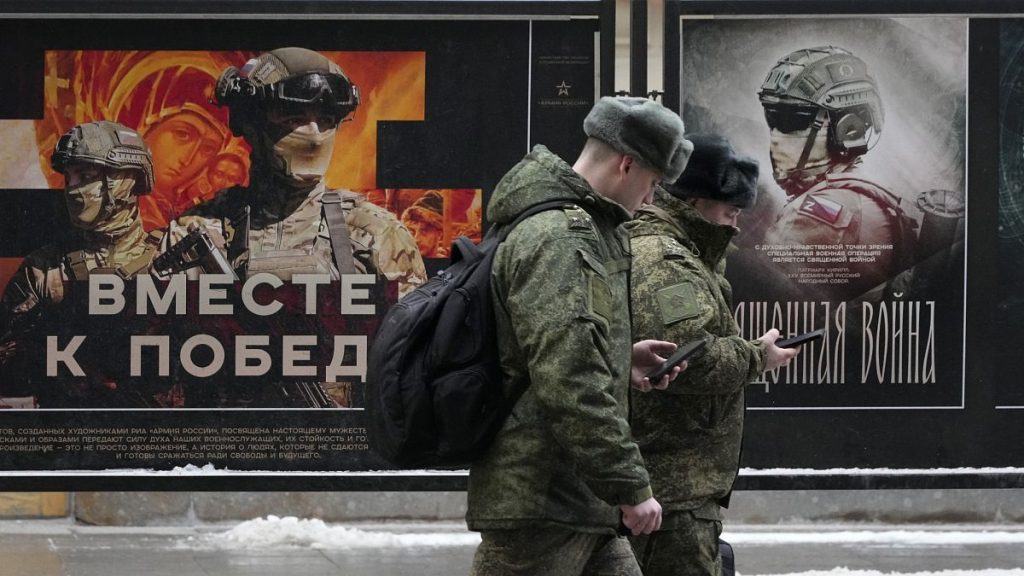 Russian army officers walk past a street exhibition dedicated to Russian army in St. Petersburg, 14 February, 2025