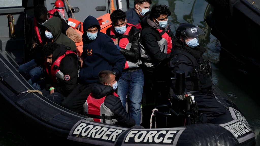 People thought to be migrants who undertook the English Channel crossing from France arrive in Dover, 17 June, 2022