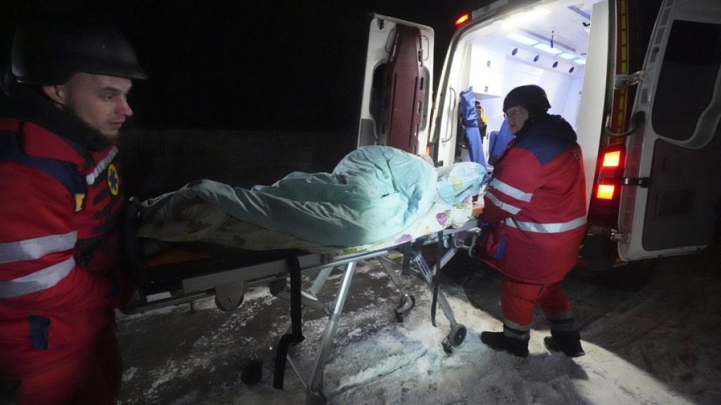 Medical workers evacuate a patient from a hospital damaged by a Russian strike in Kharkiv, Ukraine, Friday, Feb. 28, 2025.