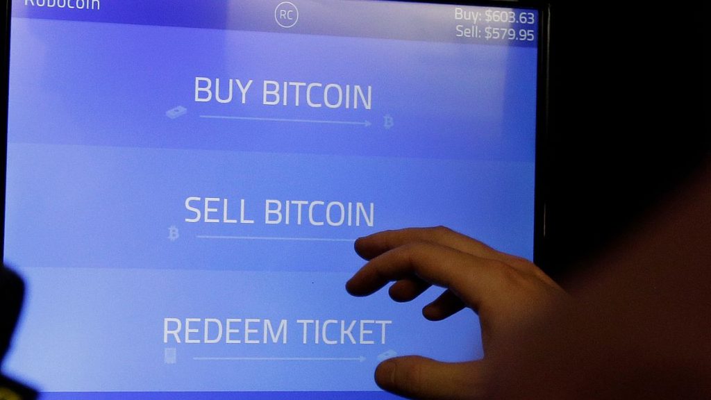 Bitcoin golden physical coin illustration on United States Dollar banknotes. FILE PHOTO